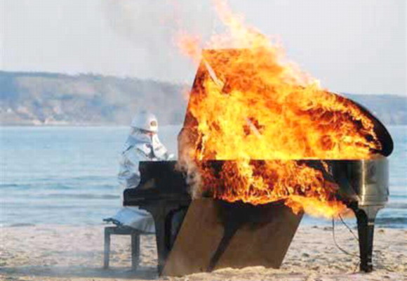 This piano is blazing! Famous Japanese pianist Yosuke Yamashita, in fireproof gear, plays the piano for 10 minutes in this firey performance peice!